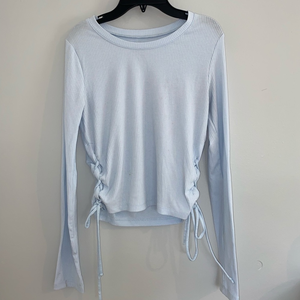 Blue long sleeved shirt with ties on the sides